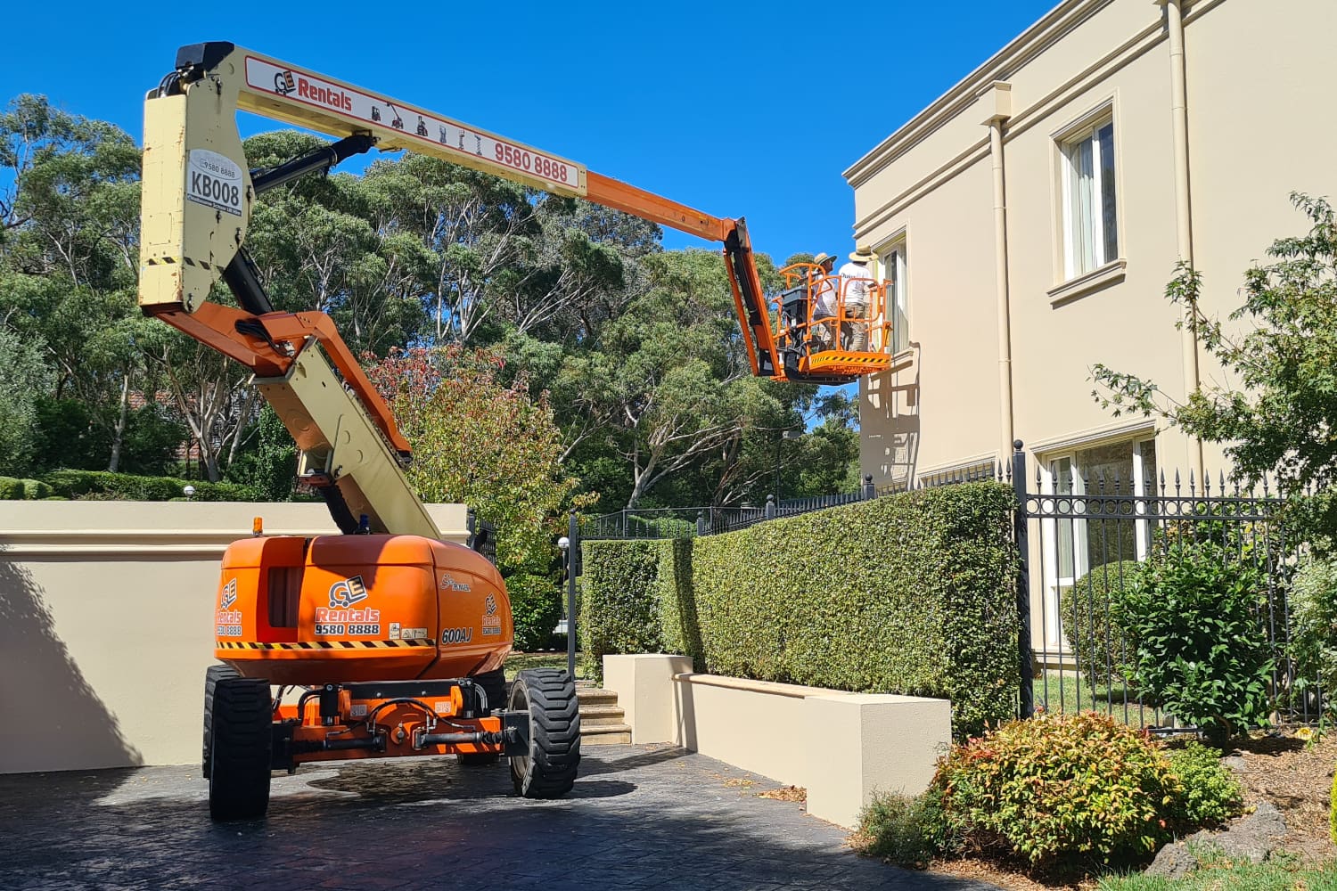 exterior house painters using a cherry picker in Melbourne suburb